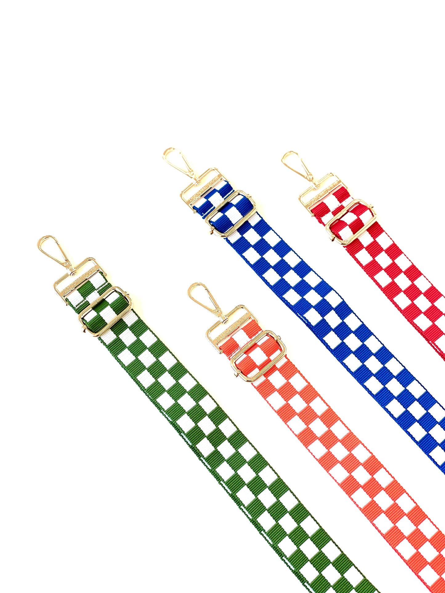 Four Drury Road Lizzie Checkered Purse Straps for Crossbody Bags on a white background in the colors green and white, orange and white, blue and white and red and white.