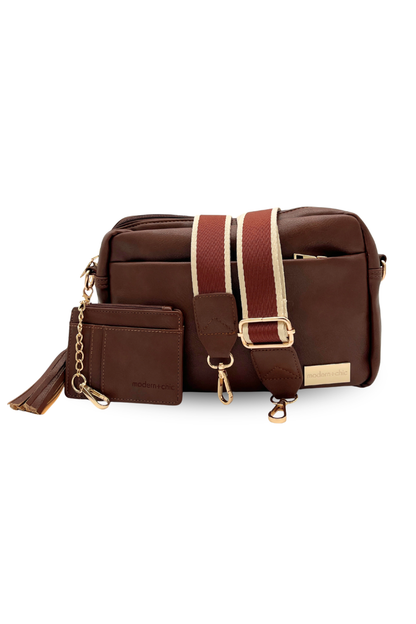 A coffee colored Drury Road Alice Crossbody vegan leather bag displaying included key leash, matching wallet and removable tassel. 