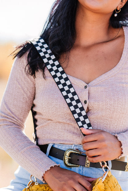 Woman is wearing a Black and white Drury Road Lizzie Checkered Purse Strap for Crossbody Bags. 