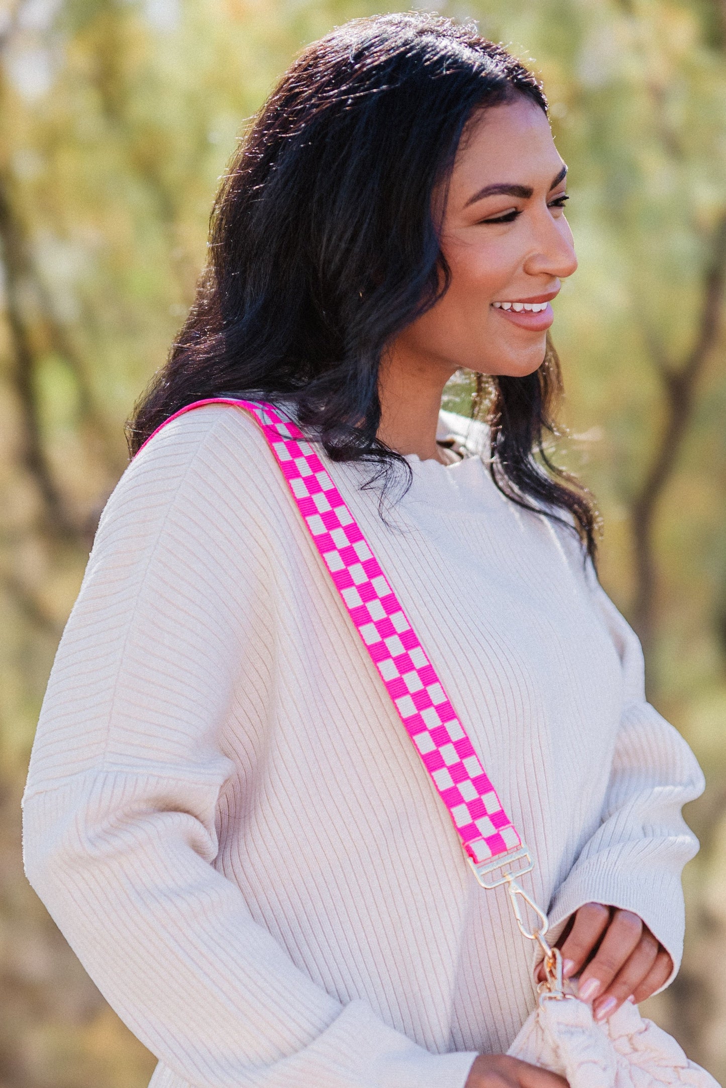 Woman wearing a hot pink and white Drury Road Lizzie Adjustable purse strap for crossbody bags over her shoulder. 