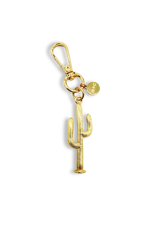 Gold cactus-shaped keychain on a white background
