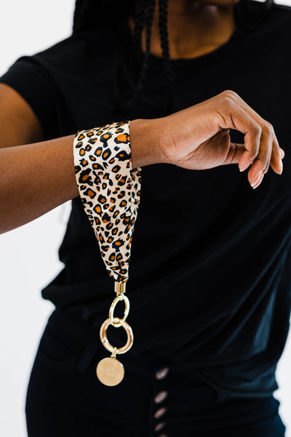A woman wearing all black wearing a Drury Road Luna Fabric Keychain Bracelet for Women around her wrist.