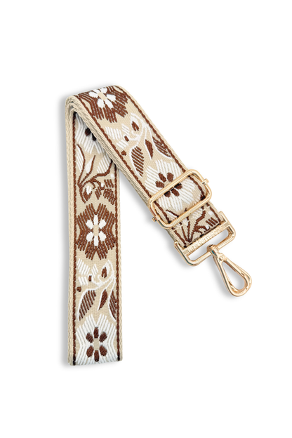 Russet Brown floral bag strap with gold hardware on a white background
