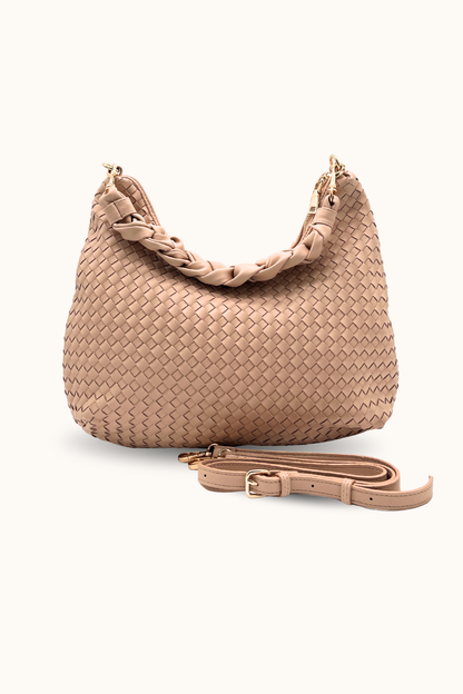 A dusty blush Drury Road Kelly Woven Convertible Crossbody Shoulder Bag with included vegan leather adjustable crossbody strap on a white background. 