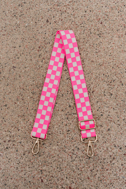 Hot pink and white Drury Road Lizzie Checkered Purse Strap for Crossbody Bags on a speckled background.