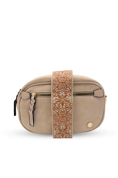 A beige Drury Road Gentry Vegan Leather Crossbody Bag on a white background.