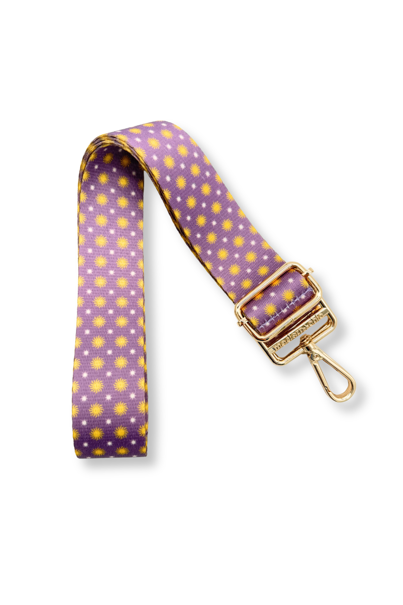 Drury Road Gleam & Glow Adjustable Purse Strap for Crossbody Bags, purple in color with gold suns and white polka dots on a white background.
