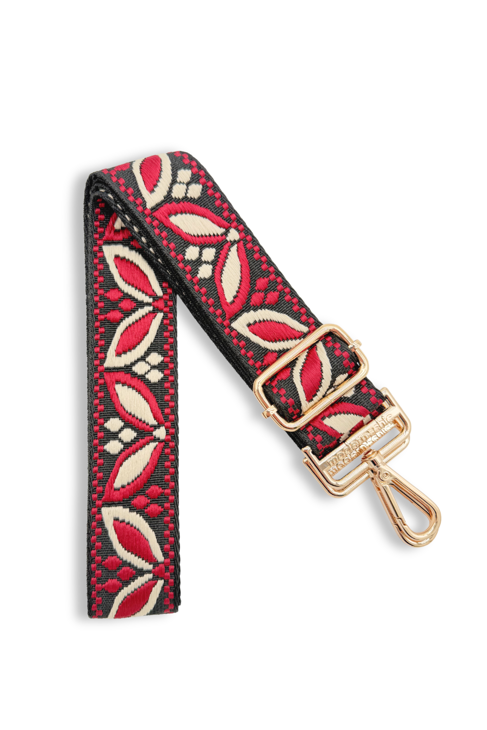 Decorative floral bag strap with red and beige pattern on a white background
