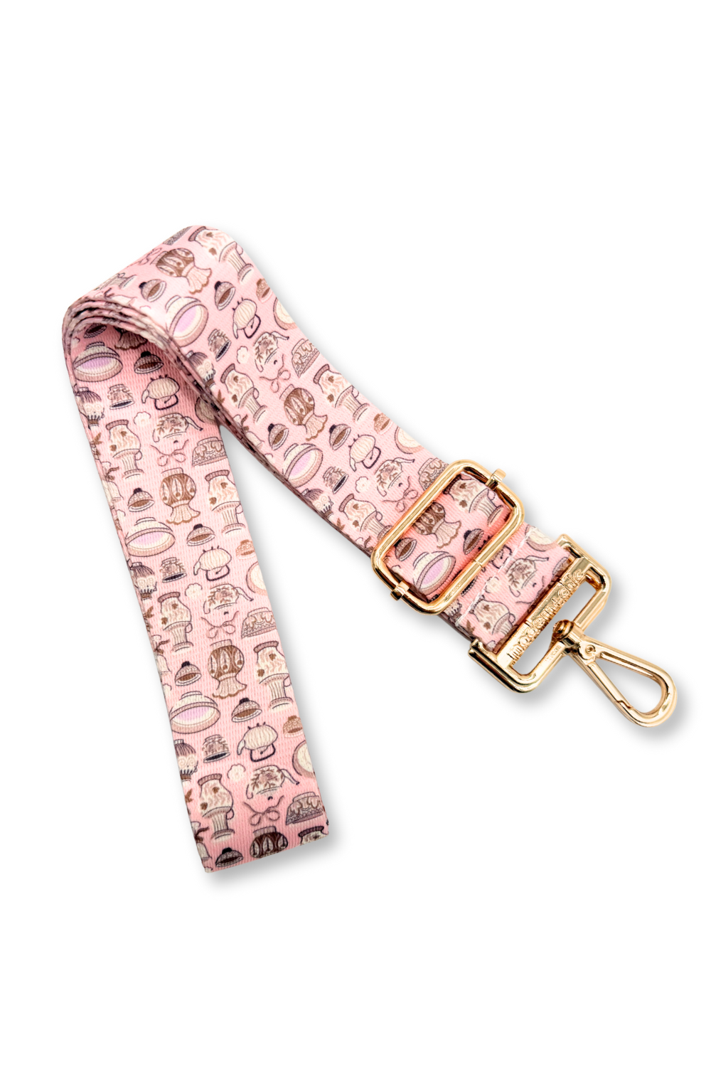 Pink teapot bag strap with gold buckle and pink pattern on a white background