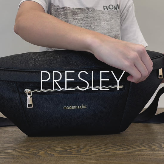 A woman showing the features and benefits of a Drury Road Presley Oversized Sling Bag for Women with gold hardware. 