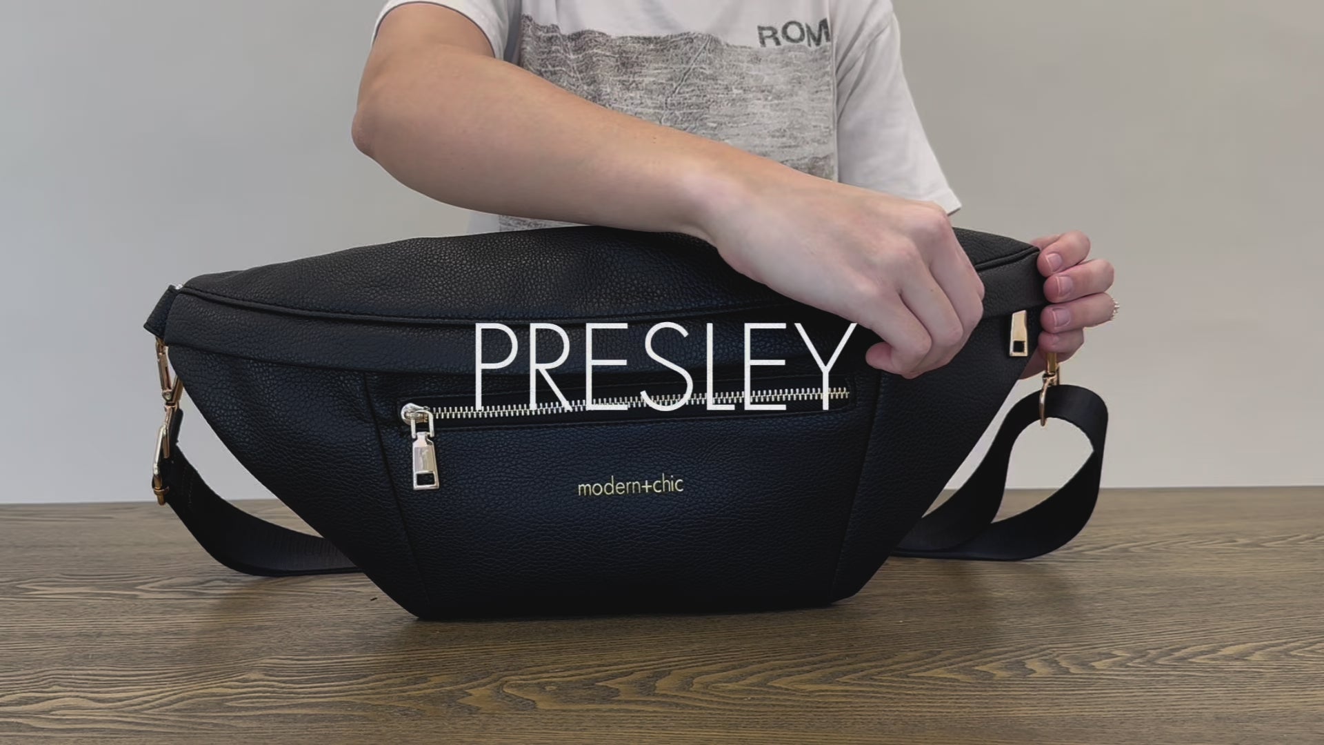 A woman showing the features and benefits of a Drury Road Presley Oversized Sling Bag for Women with gold hardware. 
