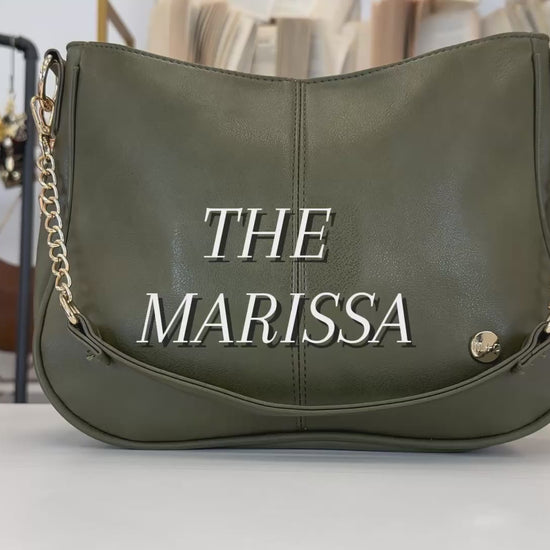 A video showing the features and benefits of a Drury Road Marissa Vegan Leather Crossbody Handbag with gold chain accents. 