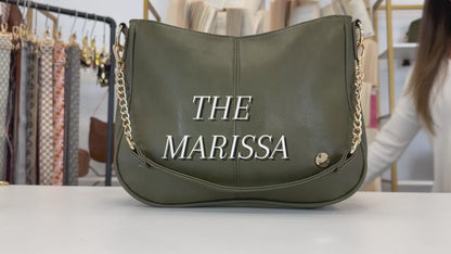 A video showing the features and benefits of a Drury Road Marissa Vegan Leather Crossbody Handbag with gold chain accents. 