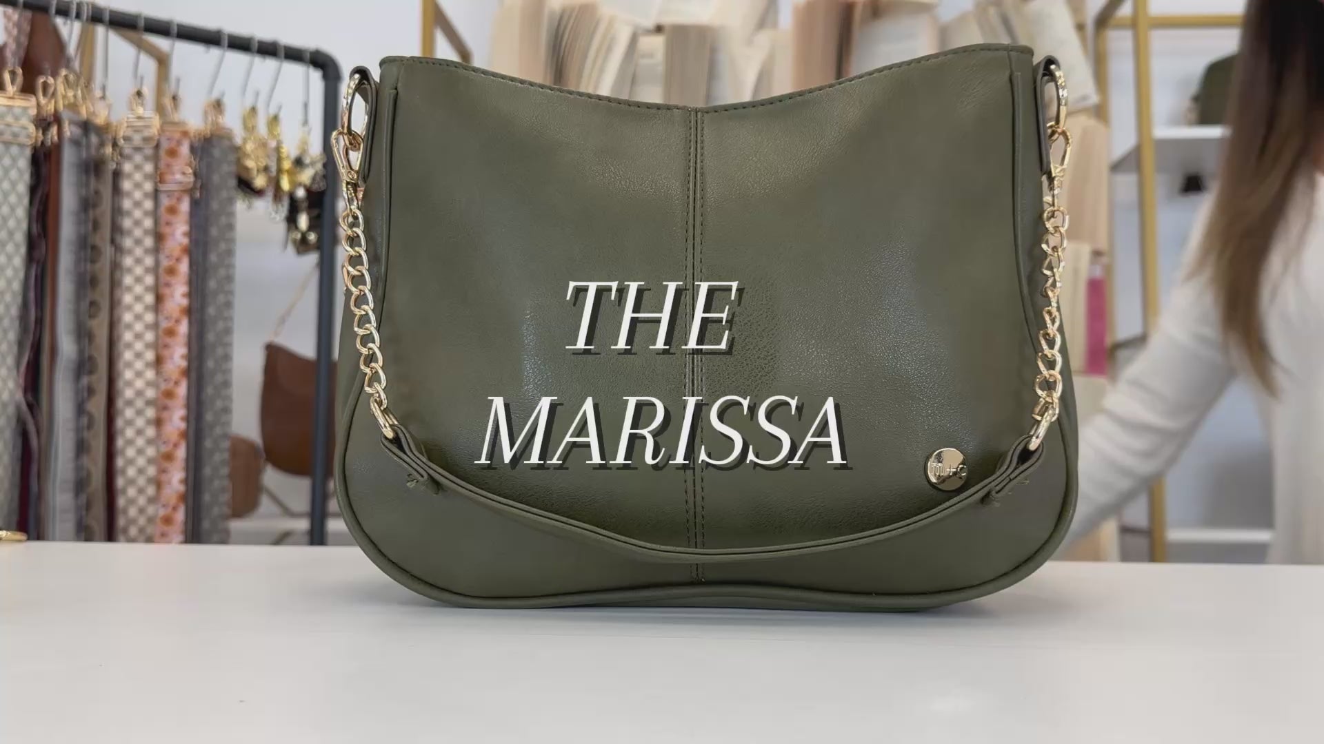 A video showing the features and benefits of a Drury Road Marissa Vegan Leather Crossbody Handbag with gold chain accents. 
