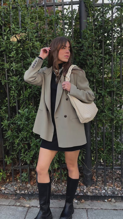 A video of a woman modeling an ivory Drury Road Kelly Woven Convertible Crossbody Shoulder Bag with included vegan leather adjustable crossbody strap outdoors.