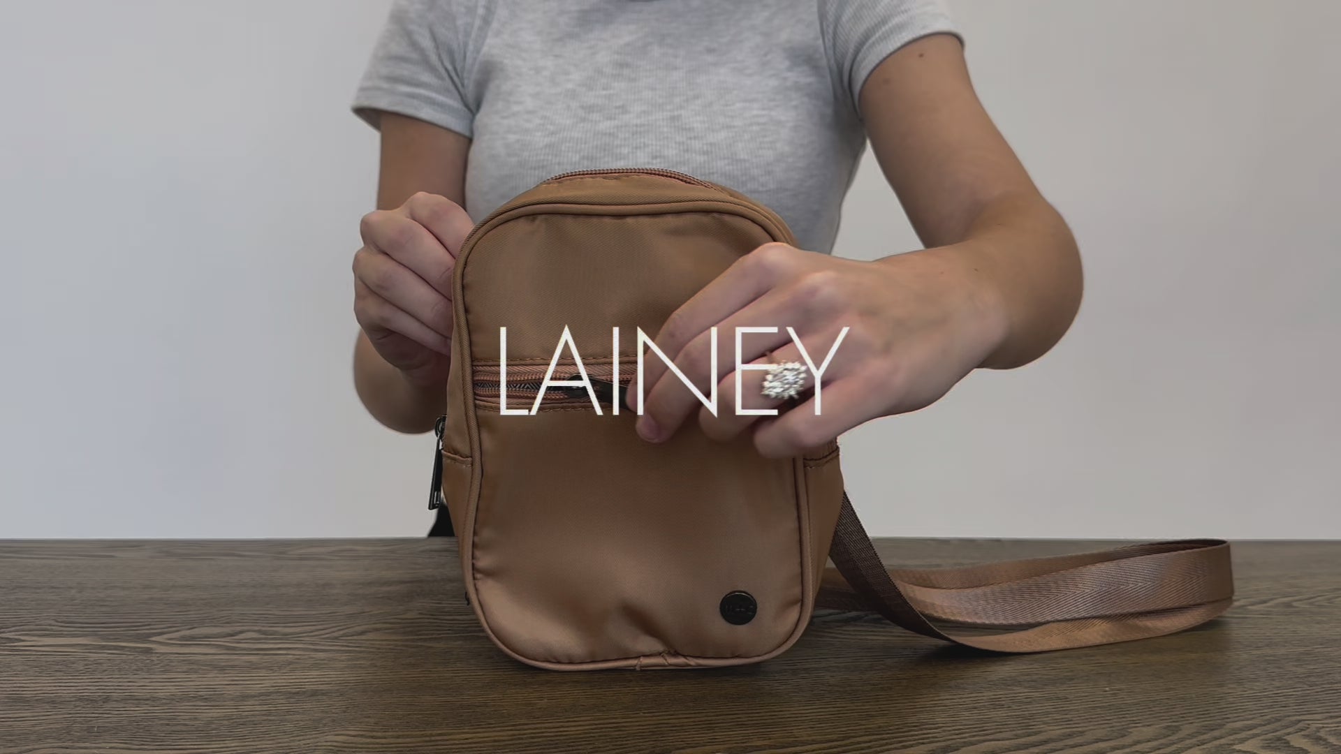 A video of a Woman showing the features and benefits of a Drury Road Lainey Convertible Crossbody Bag for Women. 