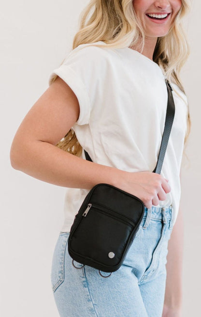 Woman wearing a black Drury Road Lainey Convertible Crossbody Bag for Women on a white top with jeans.