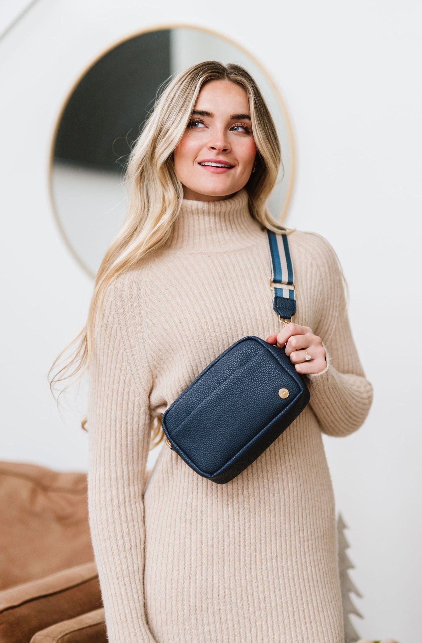 Woman wearing a blue Drury Road Willow Vegan Leather Convertible Crossbody Bag on a white background. 